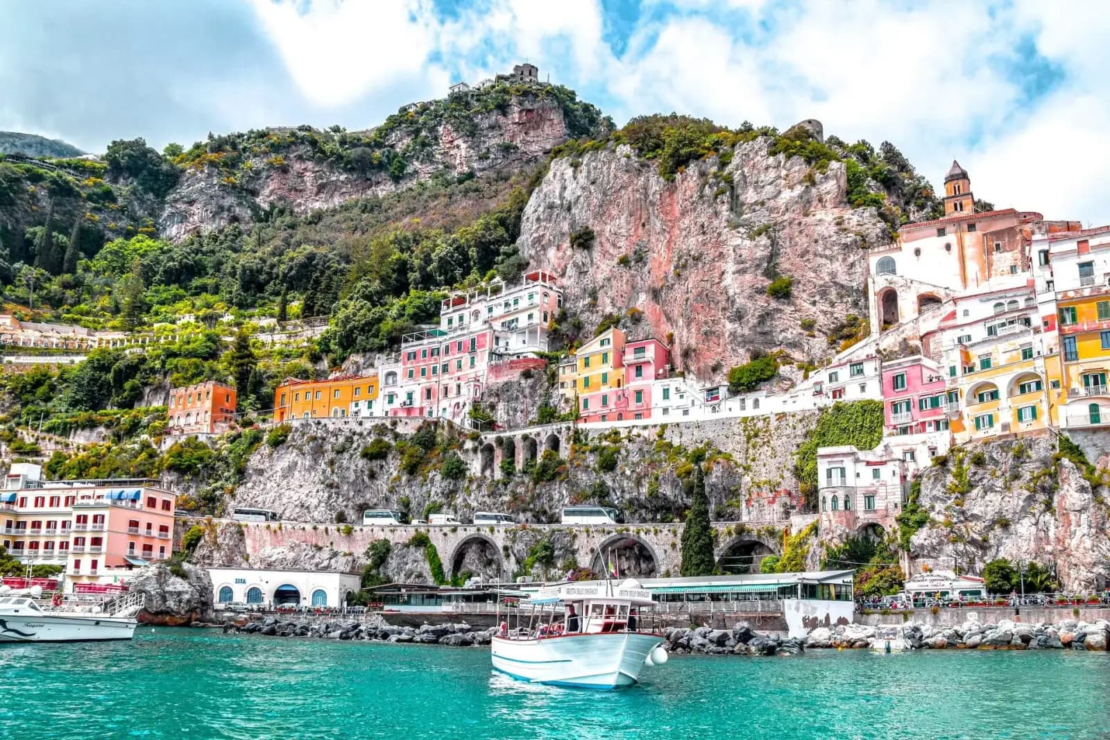 Pastel houses cascading down cliffs on the Amalfi Coast