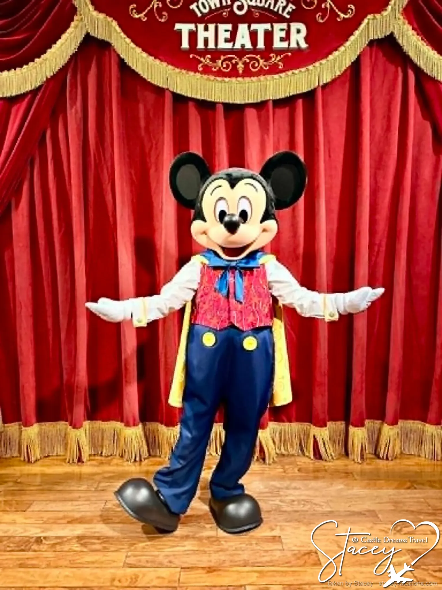 Mickey Mouse in his red bandleader jacket greeting guests at a Walt Disney World meet and greet