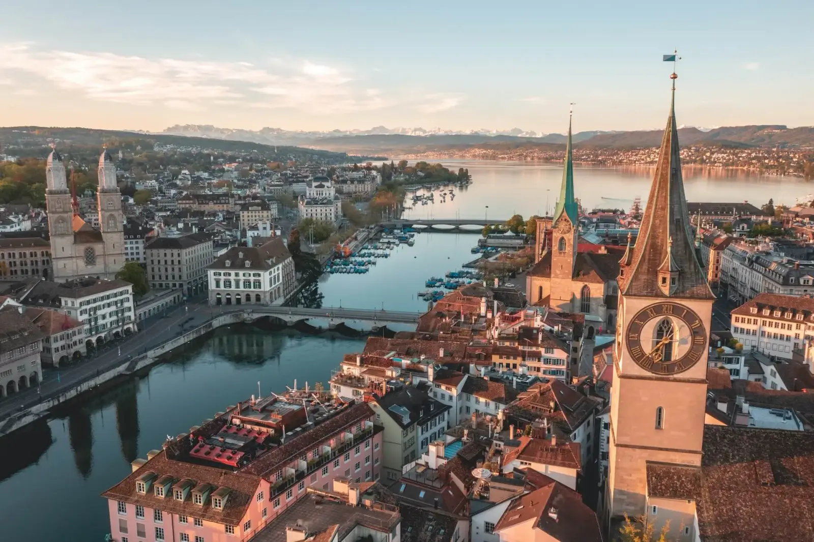 Zurich's old town along the Limmat River with the Alps beyond